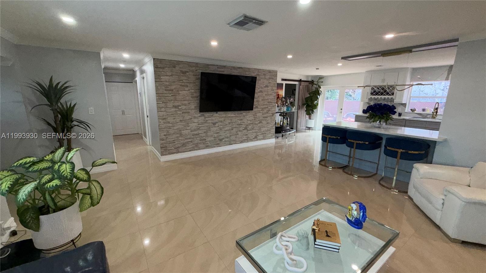 10550 Southwest 51st Street Cooper City, FL 33328 - Photo 12 of 37 a living room with furniture and a flat screen tv