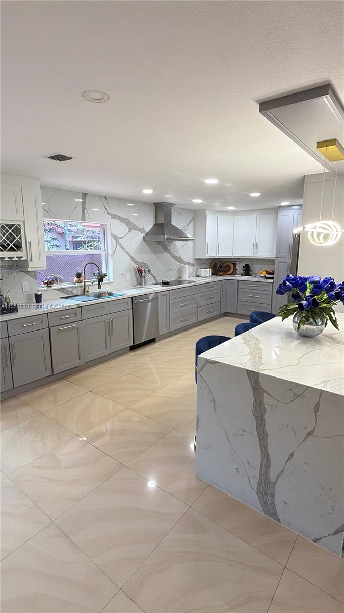 10550 Southwest 51st Street Cooper City, FL 33328 - Photo 13 of 37 a kitchen with stainless steel appliances a sink cabinets and counter top space