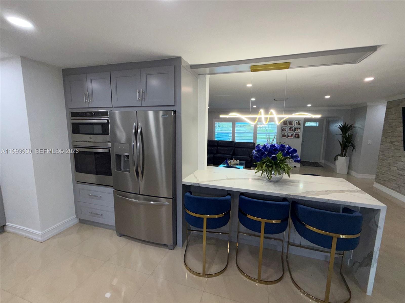 10550 Southwest 51st Street Cooper City, FL 33328 - Photo 16 of 37 a kitchen with a refrigerator and microwave