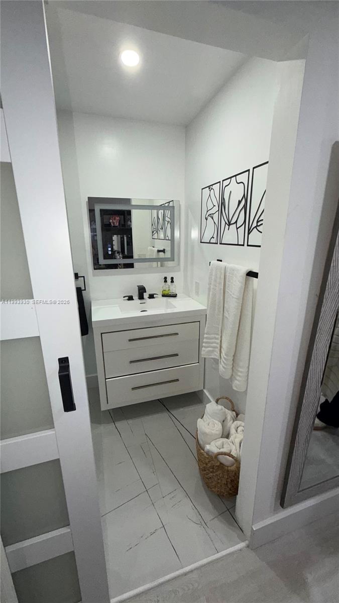 10550 Southwest 51st Street Cooper City, FL 33328 - Photo 19 of 37 a bathroom with a sink toilet and a mirror