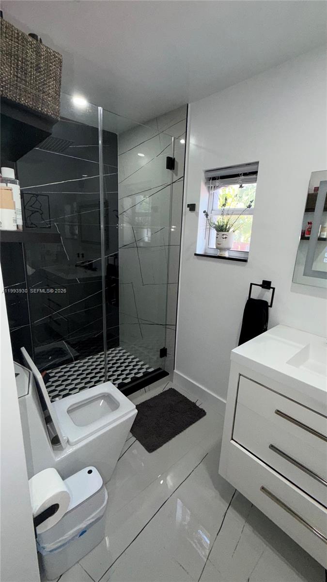 10550 Southwest 51st Street Cooper City, FL 33328 - Photo 20 of 37 a bathroom with a sink a toilet and shower