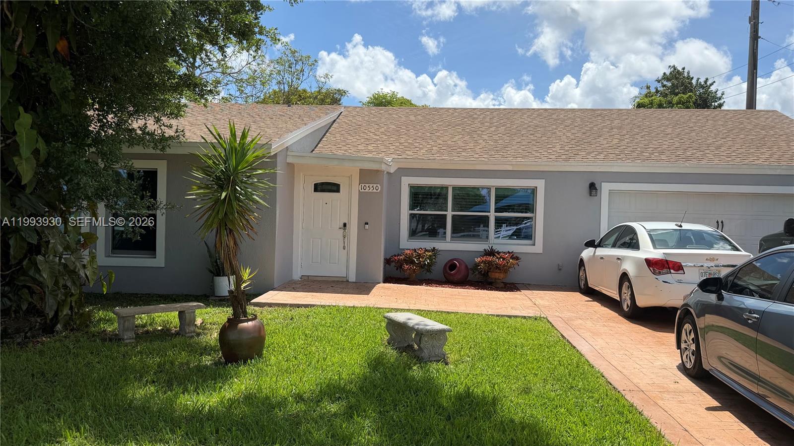 10550 Southwest 51st Street Cooper City, FL 33328 - Photo 2 of 37 a front view of a house with garden