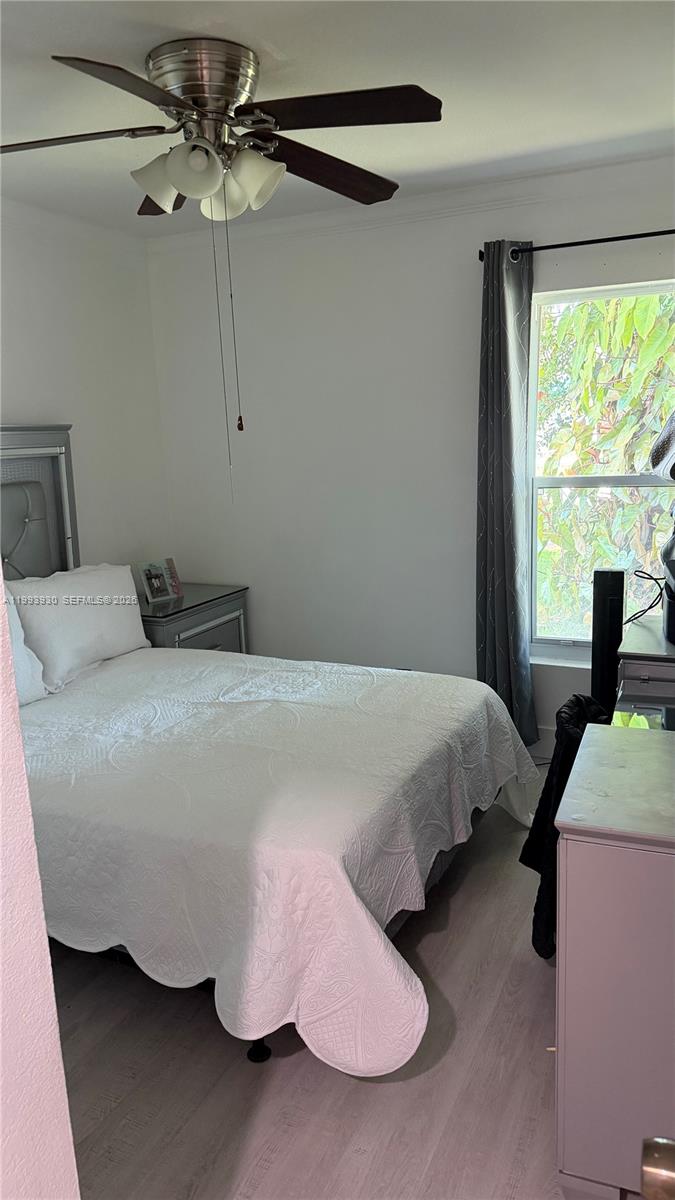 10550 Southwest 51st Street Cooper City, FL 33328 - Photo 21 of 37 a bedroom with bed and window