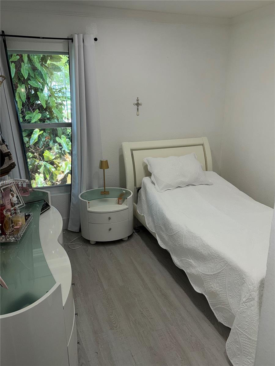 10550 Southwest 51st Street Cooper City, FL 33328 - Photo 22 of 37 a bed sitting in a room next to a window
