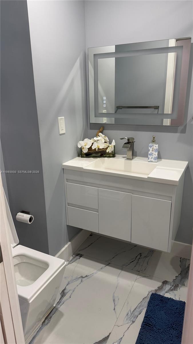 10550 Southwest 51st Street Cooper City, FL 33328 - Photo 24 of 37 a bathroom with a sink and a mirror