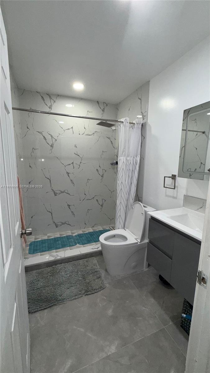 10550 Southwest 51st Street Cooper City, FL 33328 - Photo 27 of 37 a bathroom with a sink a toilet and shower