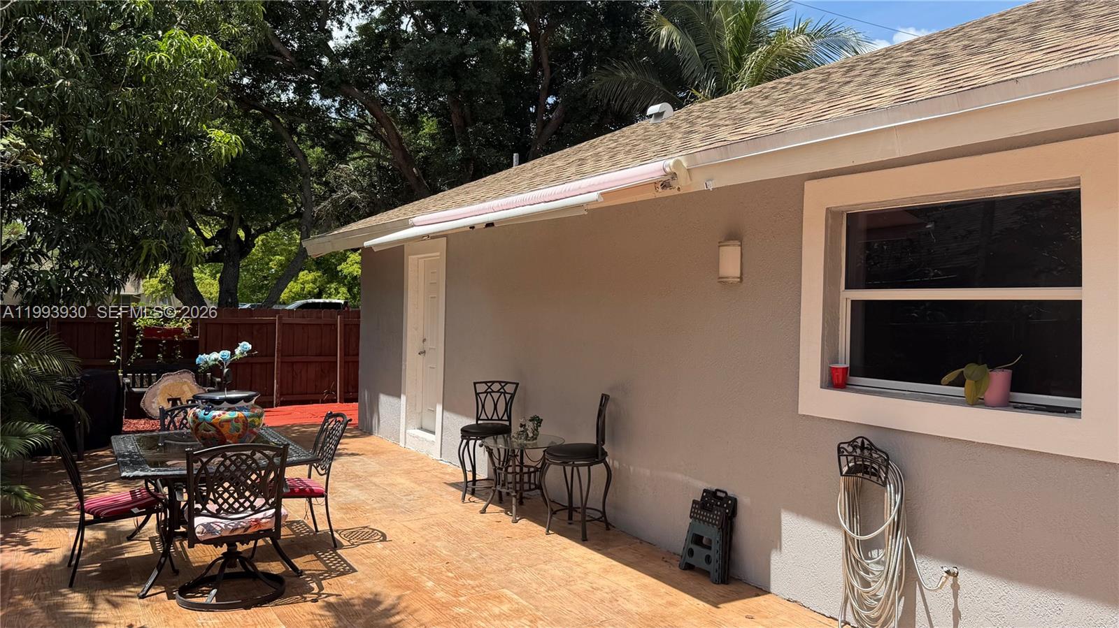 10550 Southwest 51st Street Cooper City, FL 33328 - Photo 32 of 37 a view of a patio with table and chairs and potted plants