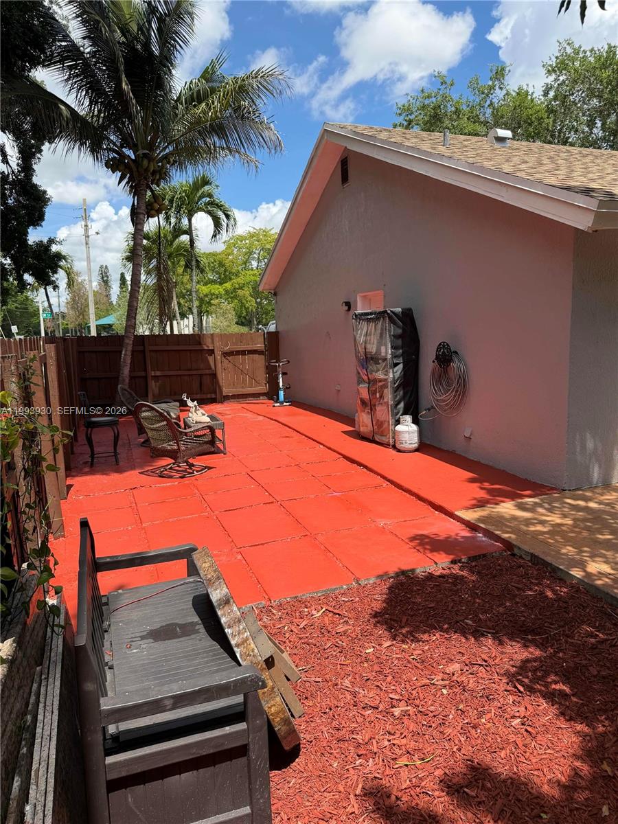 10550 Southwest 51st Street Cooper City, FL 33328 - Photo 35 of 37 a view of a patio with a table chairs and a fire pit