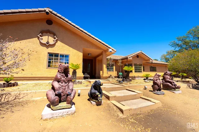 a kitchen with stainless steel appliances granite countertop a sink a stove and a wooden floors