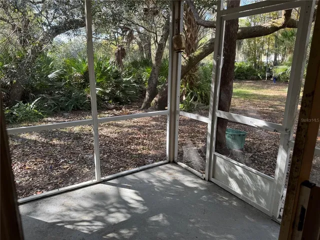 a view of a yard with wooden fence