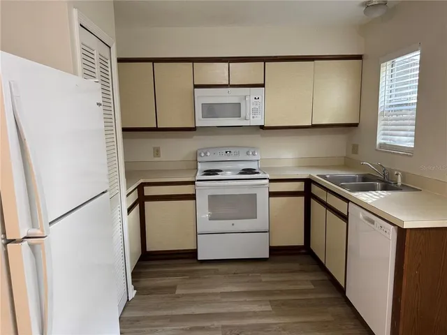 a kitchen with a stove cabinets and a wooden floor