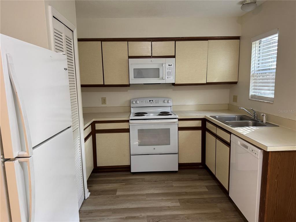 513 Green Spring Circle Winter Springs, FL 32708 - Photo 4 of 12 a kitchen with a stove cabinets and a wooden floor