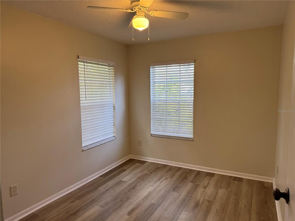 513 Green Spring Circle Winter Springs, FL 32708 - Photo 7 of 12 a view of an empty room with wooden floor and a window