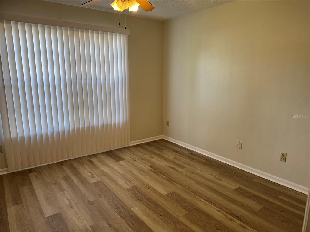 513 Green Spring Circle Winter Springs, FL 32708 - Photo 9 of 12 a view of an empty room with wooden floor and a window