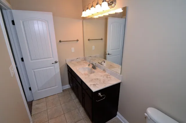 a bathroom with a sink a vanity and a mirror