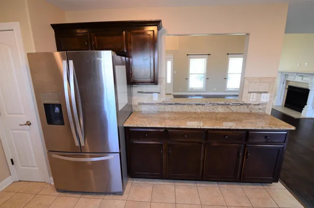 a kitchen with a refrigerator and microwave