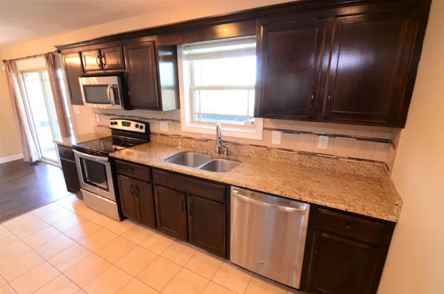 a kitchen with wooden cabinets and a sink