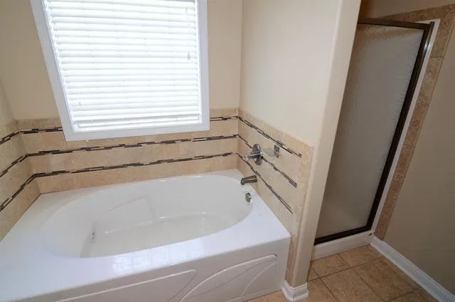 a bathroom with a bathtub and a window