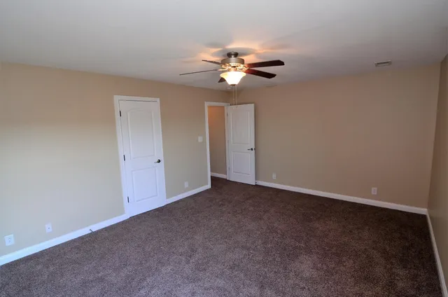 a view of an empty room with a fan