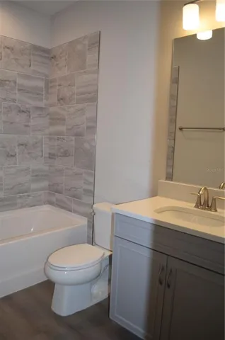 a bathroom with a toilet a sink and bathtub