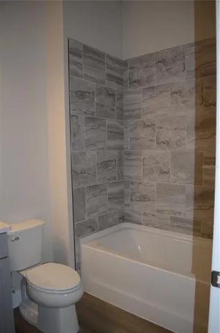 a bathroom with a bathtub and a toilet