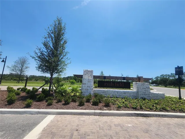 a front view of a house with a garden and plants