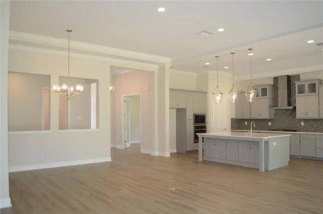 a large kitchen with a sink and cabinets