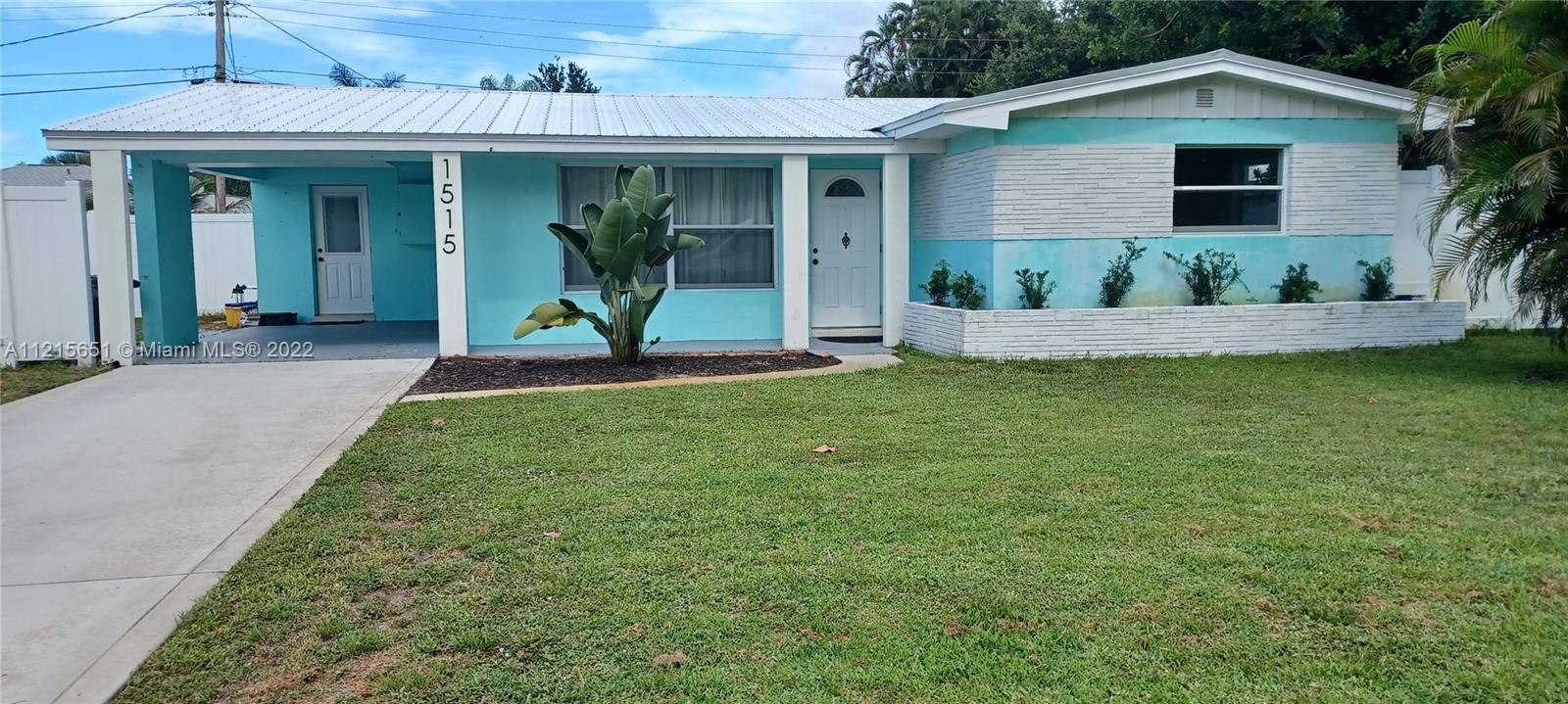 1515 Seabrook Road Jupiter, FL 33469 - Photo 1 of 29 a view of a house with a yard and plants