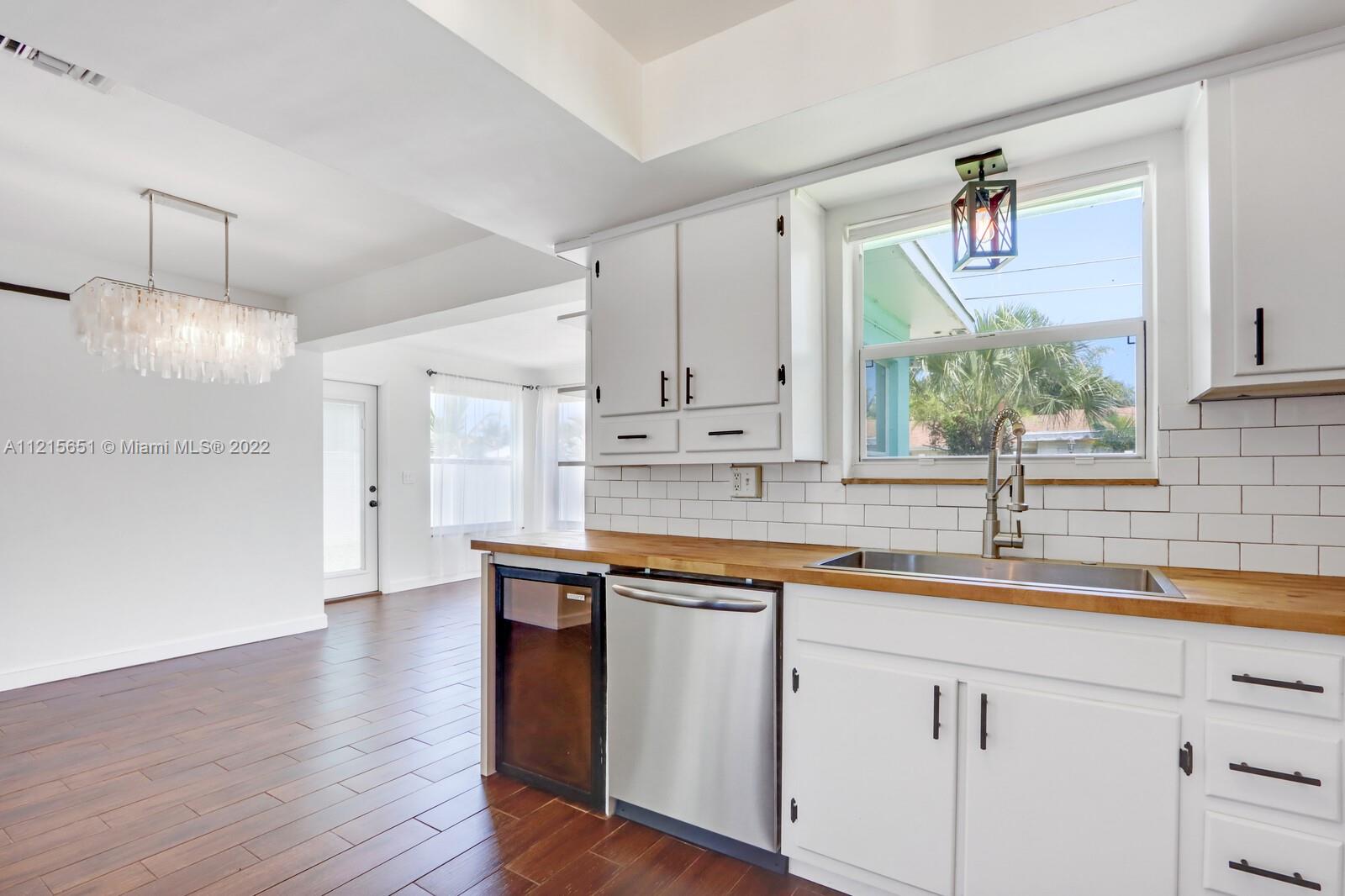 1515 Seabrook Road Jupiter, FL 33469 - Photo 11 of 29 a kitchen with a sink cabinets and window
