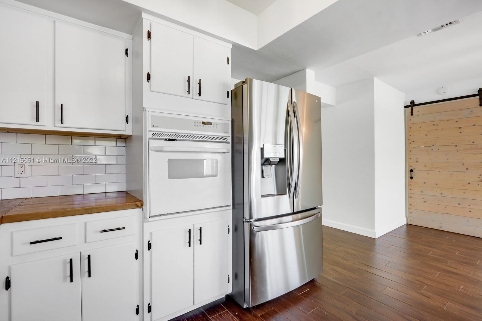 1515 Seabrook Road Jupiter, FL 33469 - Photo 12 of 29 a kitchen with stainless steel appliances a refrigerator and a sink