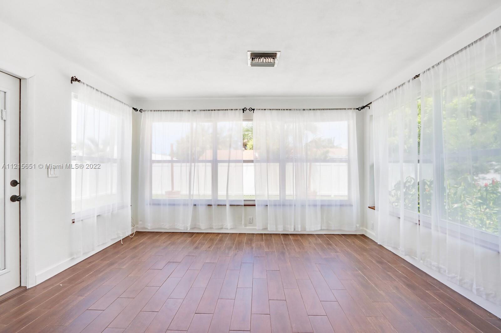 1515 Seabrook Road Jupiter, FL 33469 - Photo 14 of 29 wooden floor in an empty room with a window