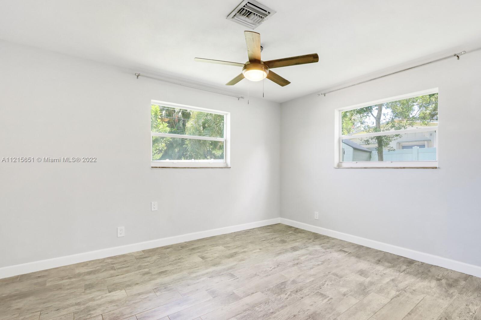 1515 Seabrook Road Jupiter, FL 33469 - Photo 17 of 29 wooden floor in an empty room with a window
