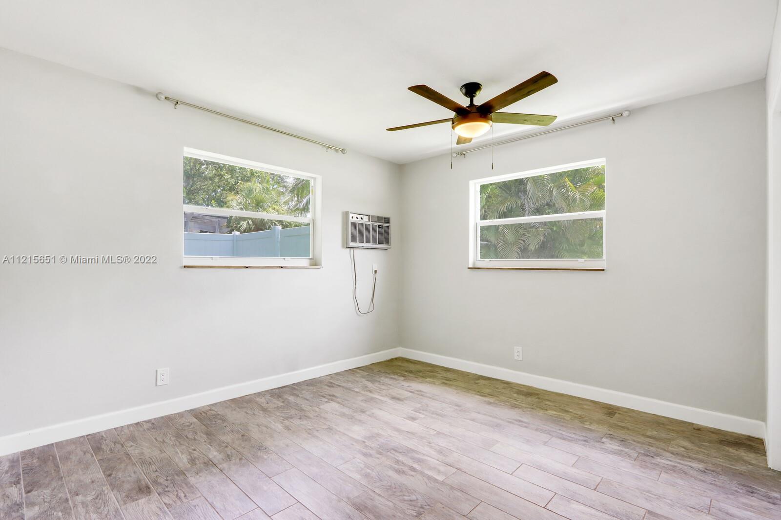 1515 Seabrook Road Jupiter, FL 33469 - Photo 22 of 29 a view of a big room with wooden floor and windows