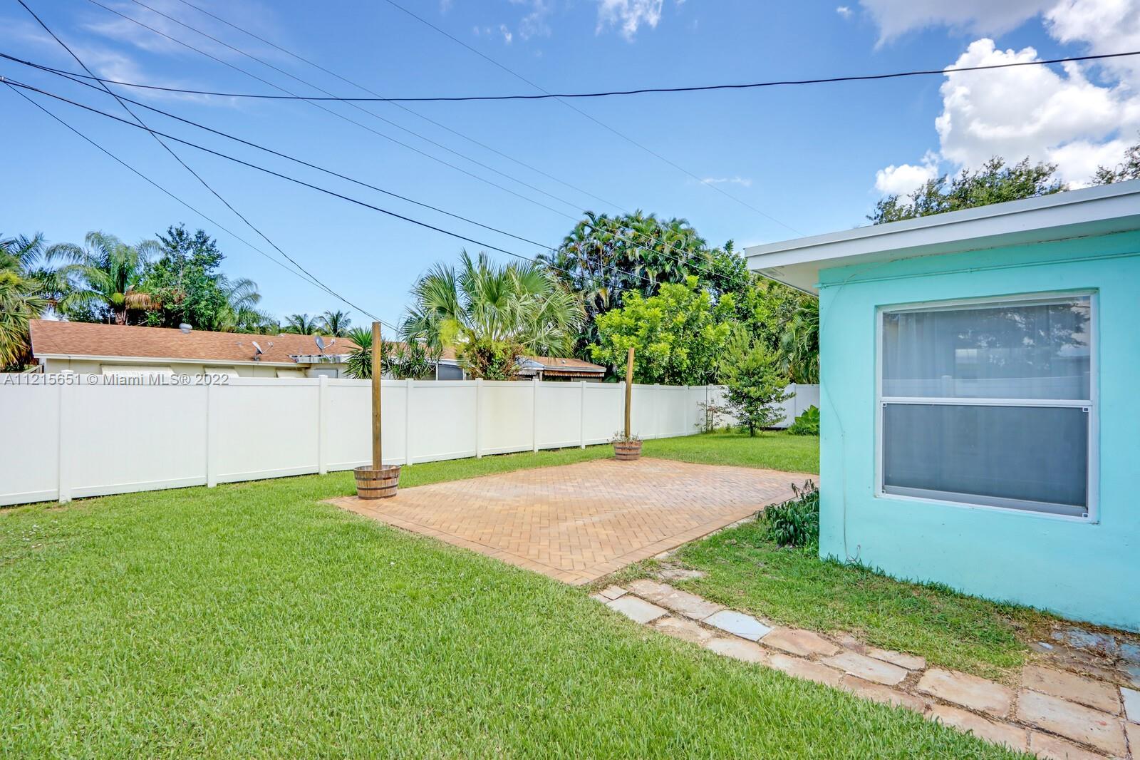 1515 Seabrook Road Jupiter, FL 33469 - Photo 24 of 29 a white house with a yard and plants