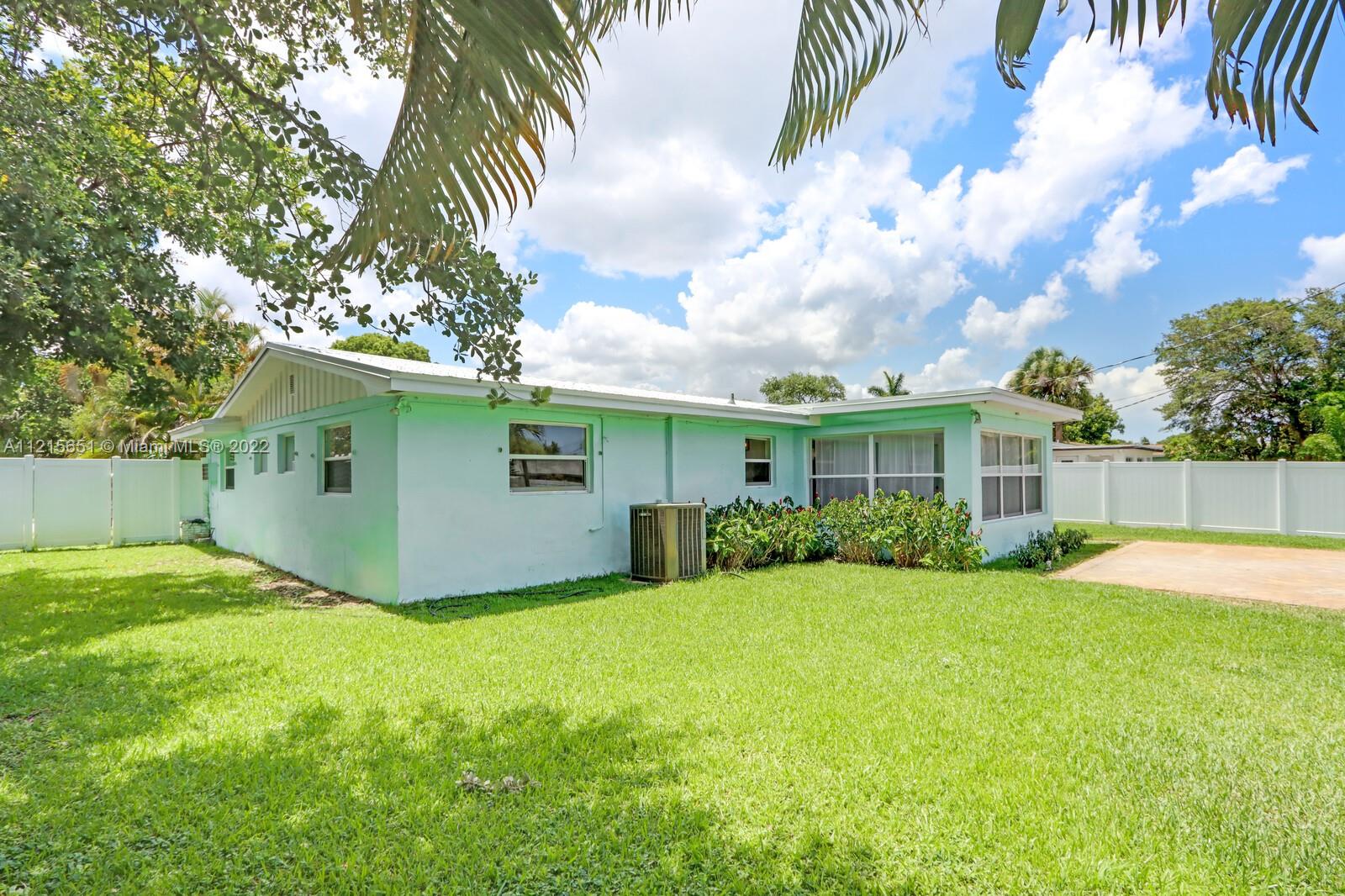 1515 Seabrook Road Jupiter, FL 33469 - Photo 27 of 29 a view of a house with a yard and plants