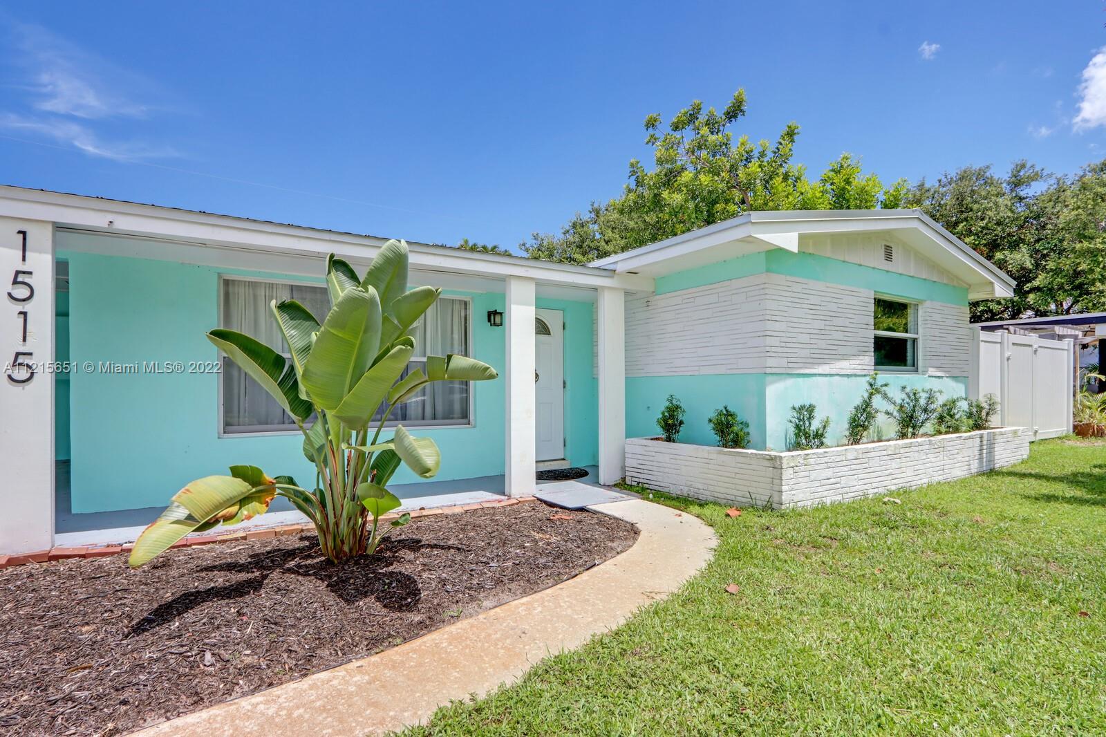 1515 Seabrook Road Jupiter, FL 33469 - Photo 3 of 29 a front view of a house with a yard