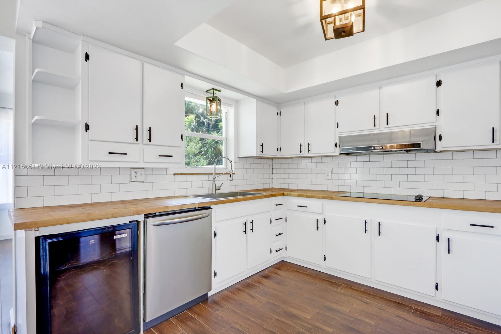1515 Seabrook Road Jupiter, FL 33469 - Photo 10 of 29 a kitchen with stainless steel appliances granite countertop a sink a stove and cabinets