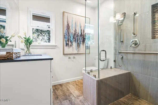 a bathroom with a bathtub sink and mirror