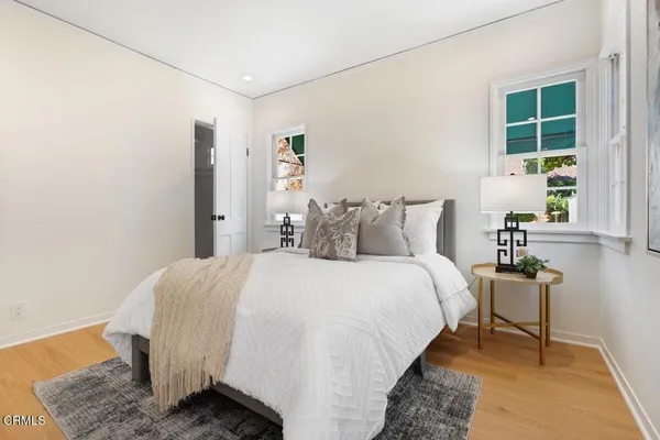 a bedroom with a bed and a potted plant