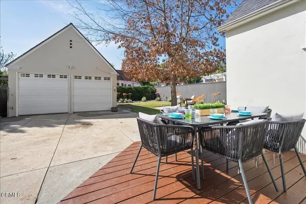 a backyard of a house with table and chairs