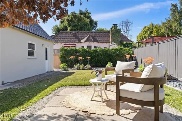 a view of a patio with table and chairs and potted plants