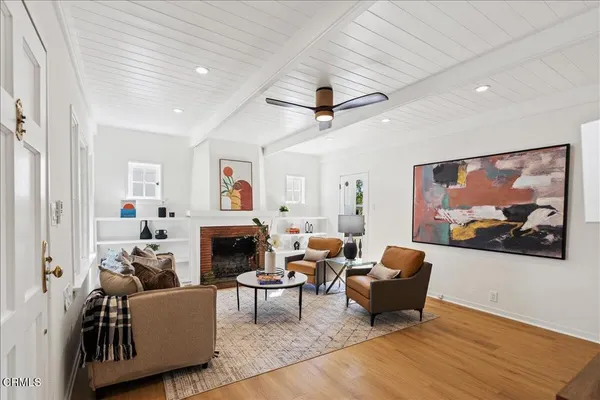 a living room with furniture a flat screen tv and a fireplace