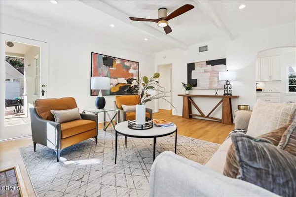 a living room with furniture and a gym equipment