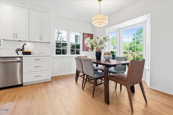 a view of a dining room with furniture window and wooden floor