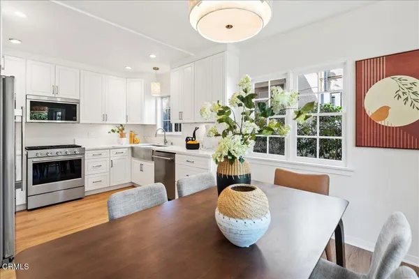 a living room with furniture a fireplace and kitchen view