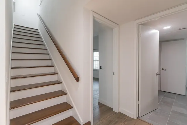 a view of entryway with wooden floor and stairs