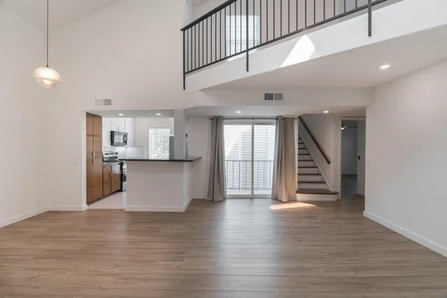 a view of kitchen and hall with wooden floor