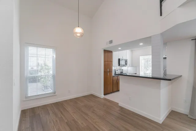 a view of kitchen with wooden floor and window