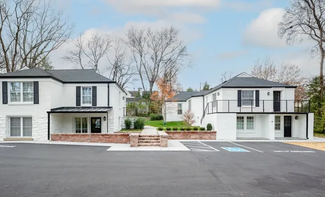 a front view of residential houses with yard