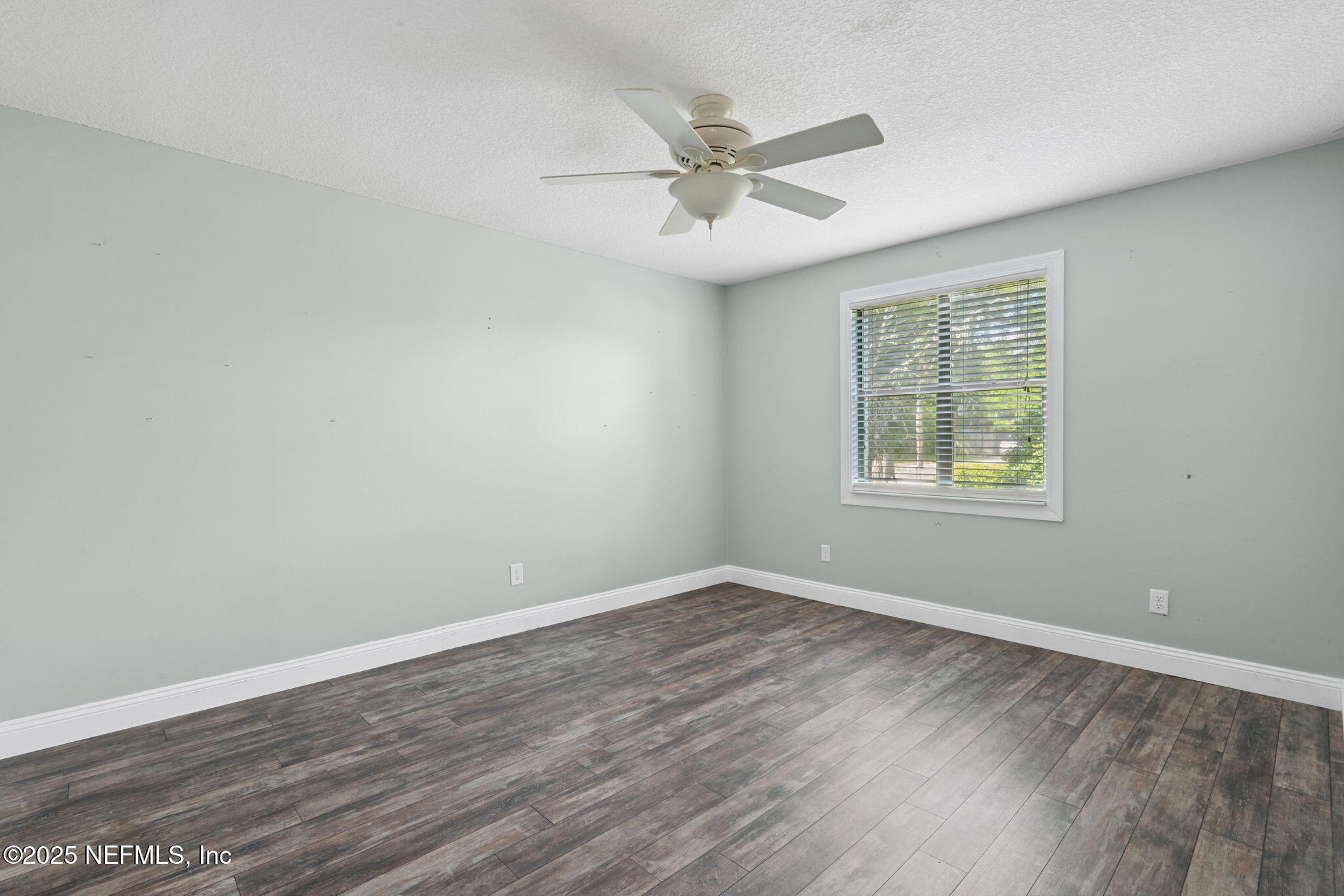 2822 Circle Ridge Drive Orange Park, FL 32065 - Photo 16 of 41 an empty room with wooden floor windows and fan